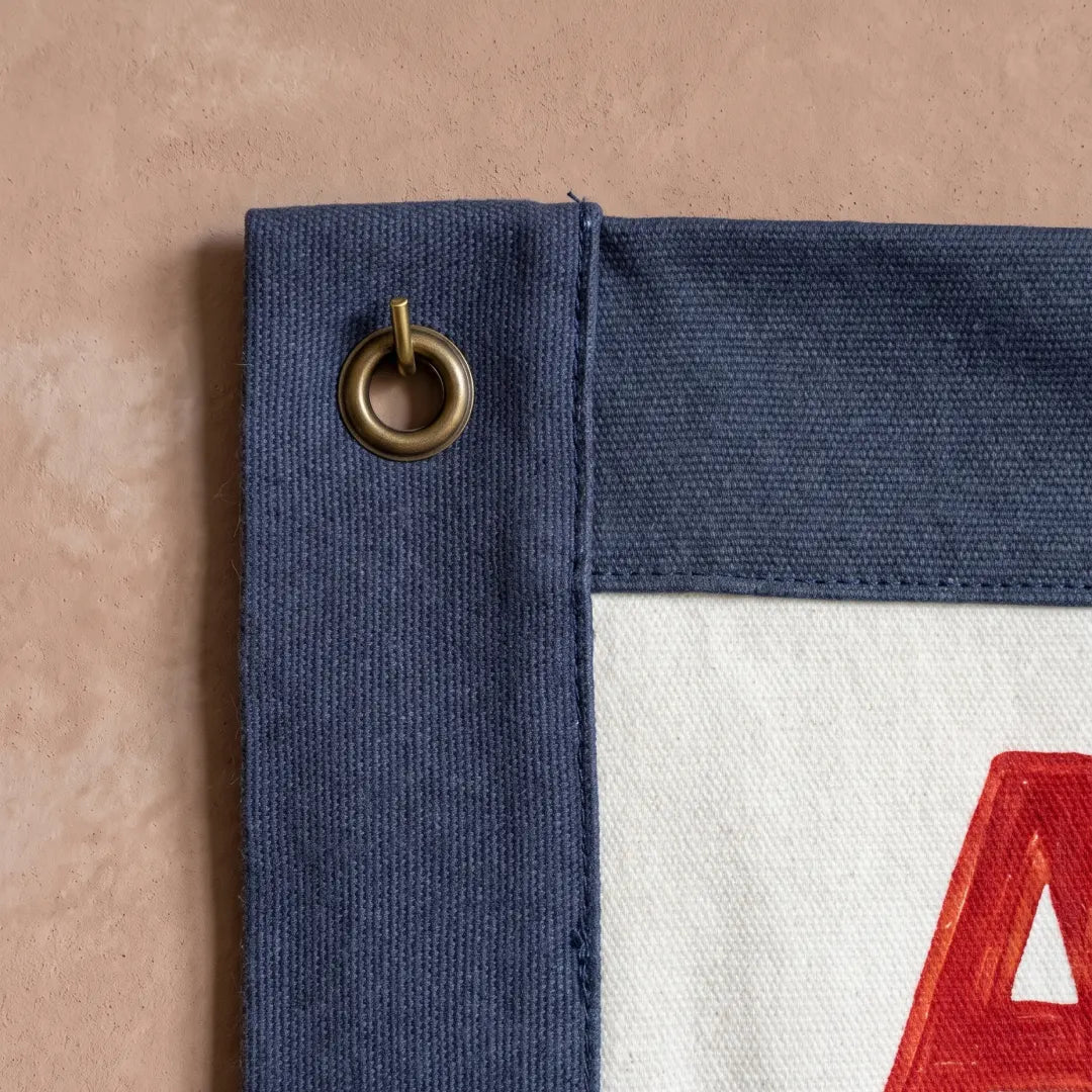 Gotta Act Right banner flag hung in a room