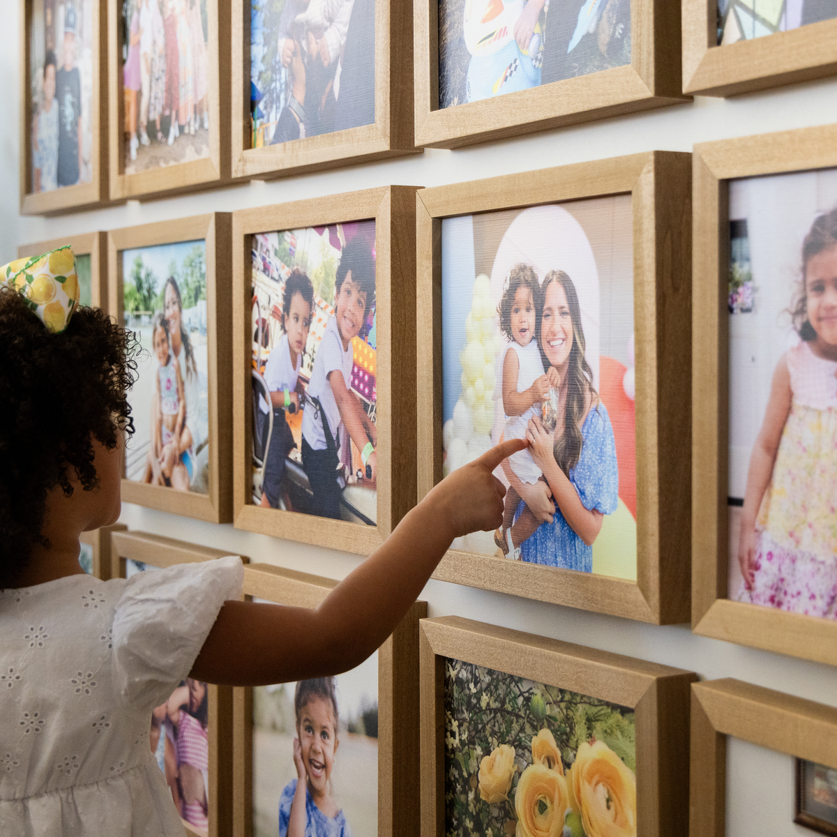 A person updating a photo in a gallery of Smallwoods wood frames
