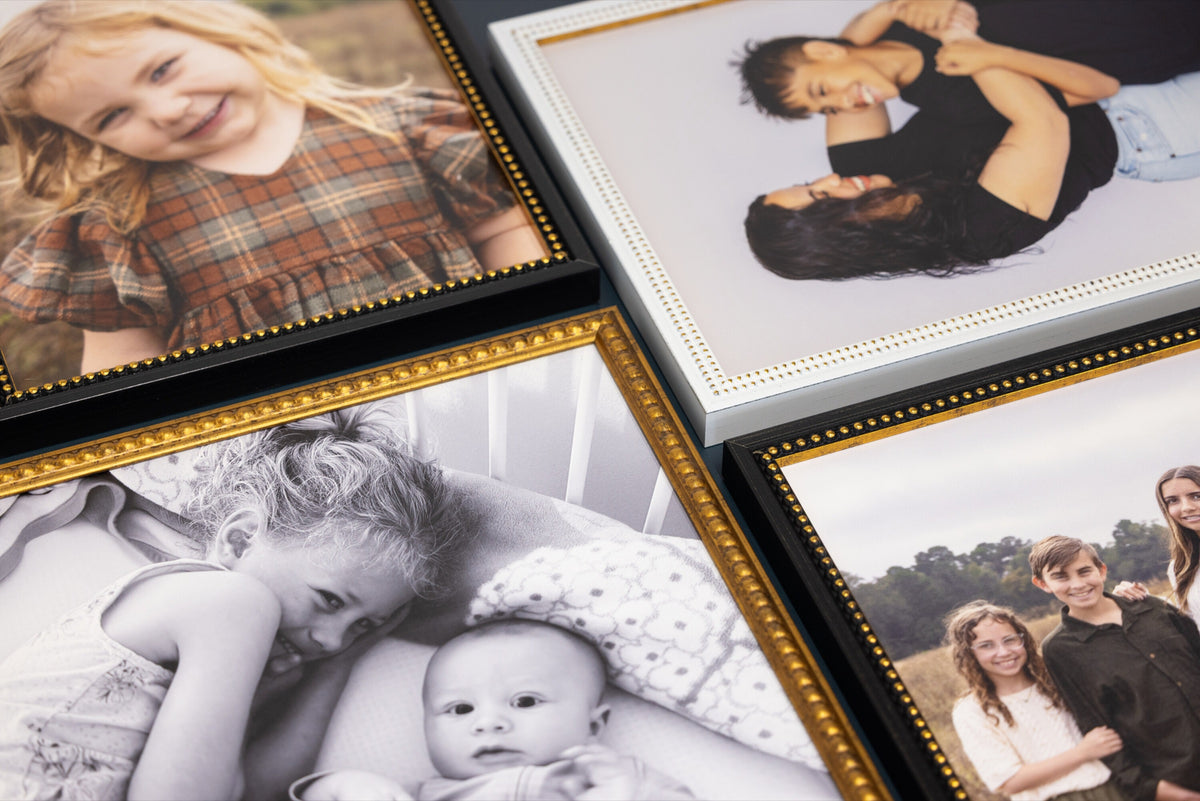 Beaded and gold frames laid flat with family photos