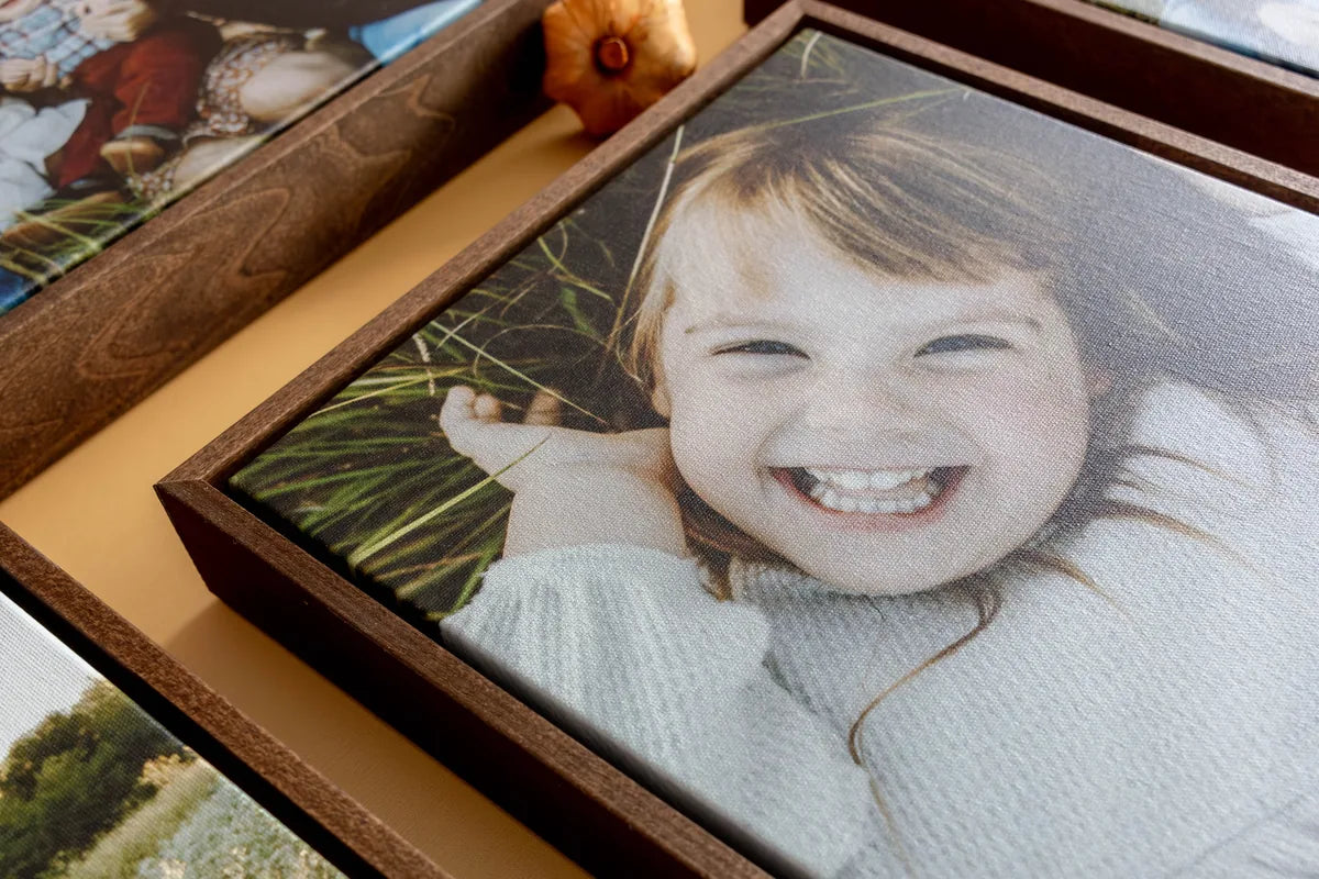 Framed Canvas prints of kids in a fall field, laid out with small pumpkins